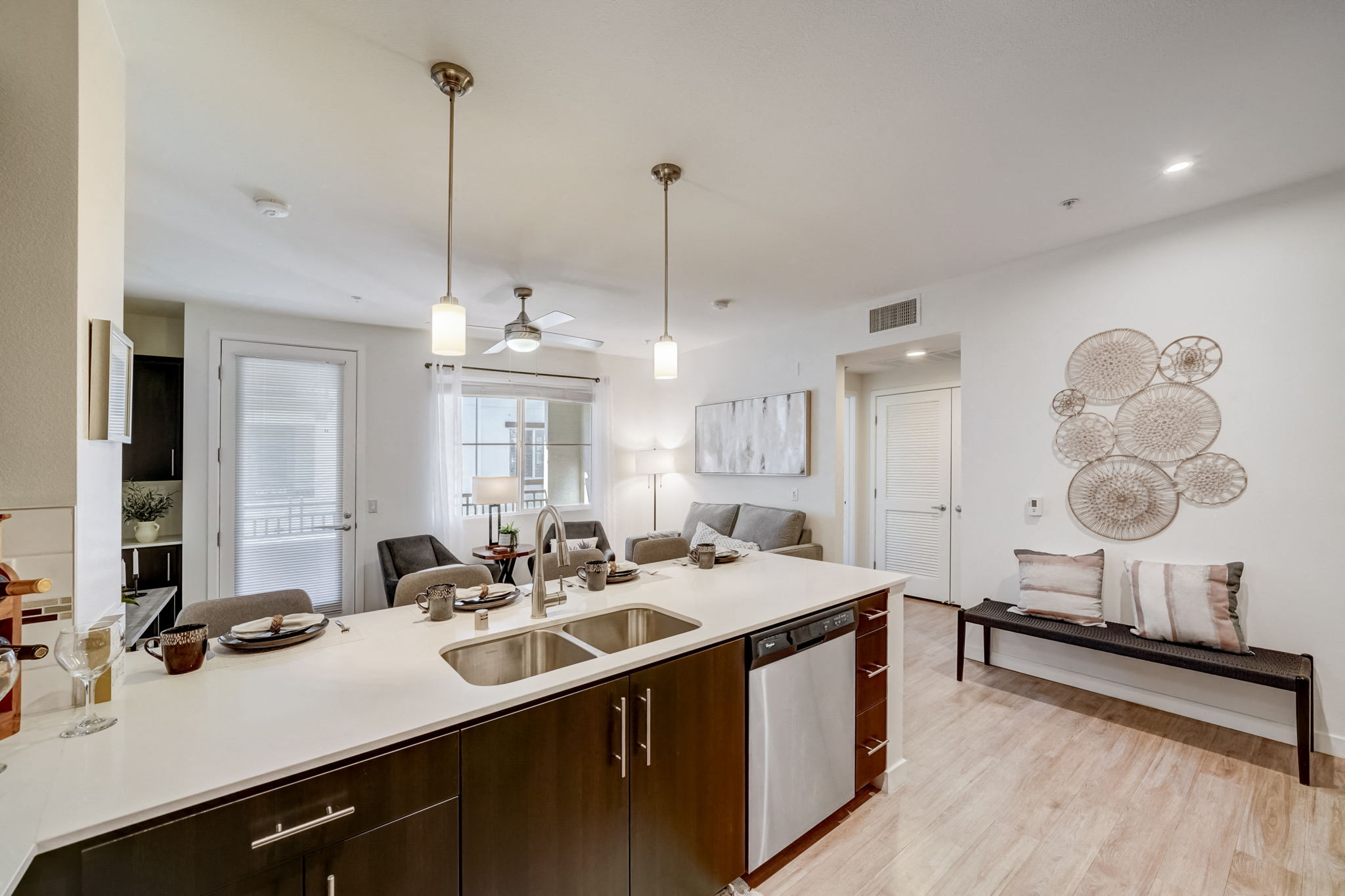 Spacious kitchen with a large island and open living room at Vistara Apartments in Ontario, CA